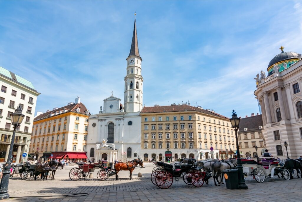 St. Michael Square Vienna with horse-drawn carriages and historic buildings