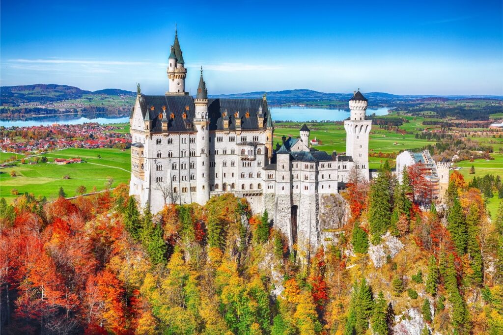 Aerial view of Schloss Neuschwanstein castle surrounded by Bavarian forests