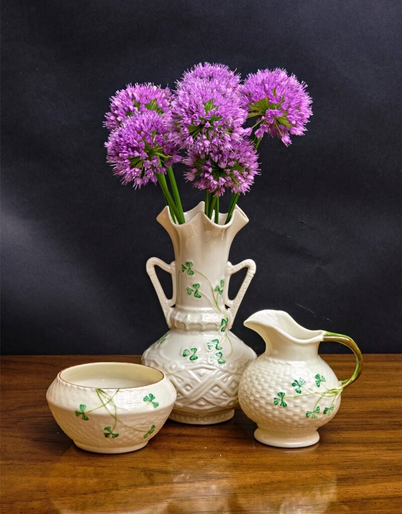 Irish Belleek vase holding vibrant Purple Sensation alliums