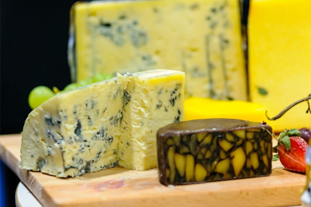 Cashel Blue and Irish Porter Cheddar cheeses on a wooden cheeseboard