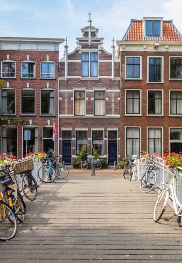 Traditional Dutch canal houses in Gouda, Netherlands with bikes parked outside