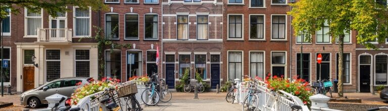 Traditional Dutch canal houses in Gouda, Netherlands with bikes parked outside