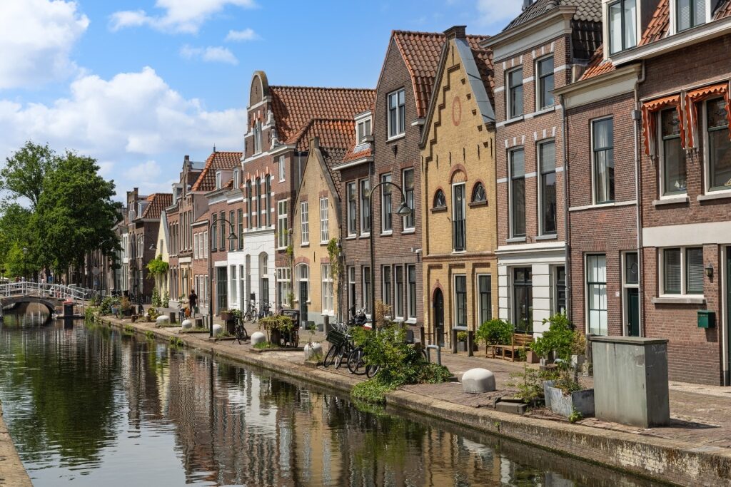 Historic canal houses lining the water in Gouda, Netherlands