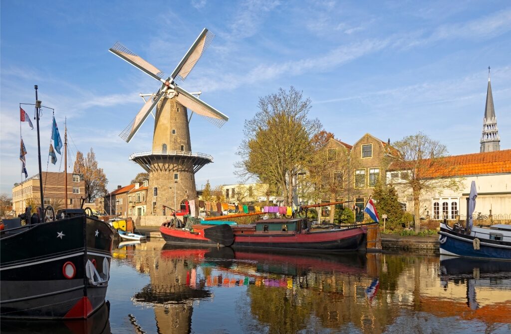 Gouda, the city of cheese, with a traditional windmill beside a canal