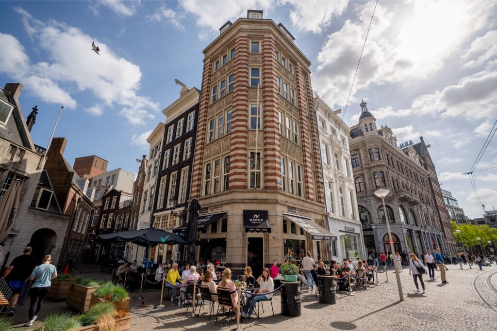 Lively outdoor café scene in Amsterdam with tourists