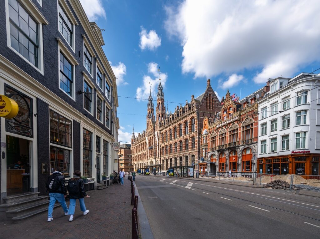 Street view in Amsterdam with the neo-Gothic Magna Plaza landmark