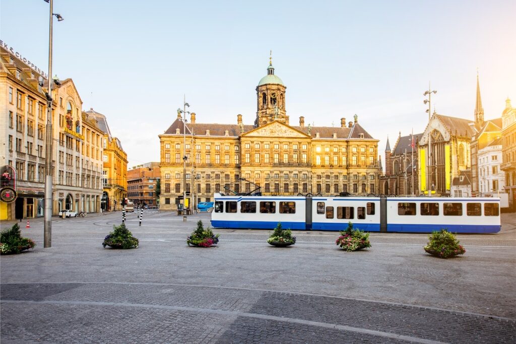 Dam Square view with the Royal Palace and tram in Amsterdam