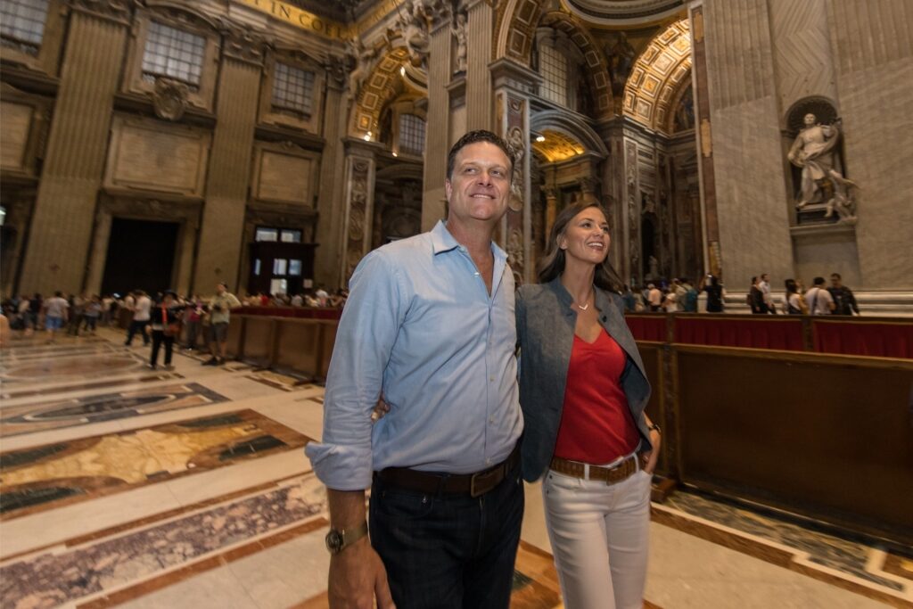 Tourist couple admiring the interior of St. Peter’s Basilica in Vatican City