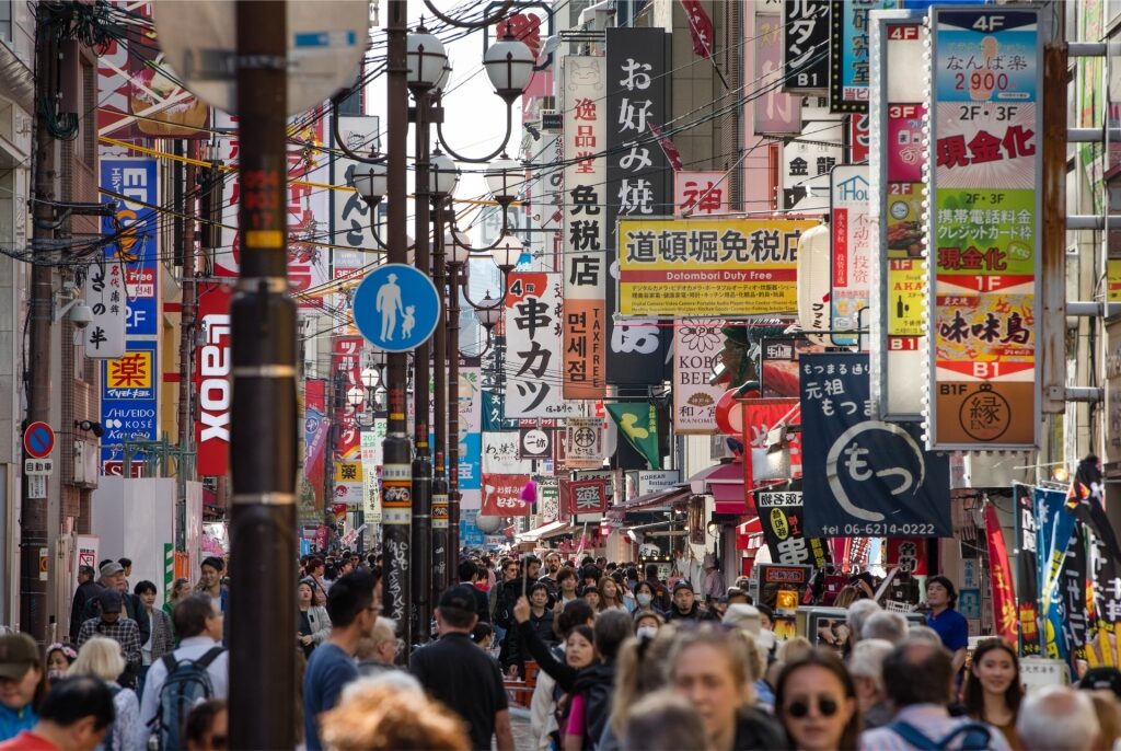Lively Dotonbori district with packed crowds and iconic Osaka signboards