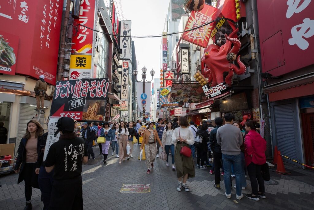 Lively Dotonbori district with packed crowds and iconic Osaka signboards