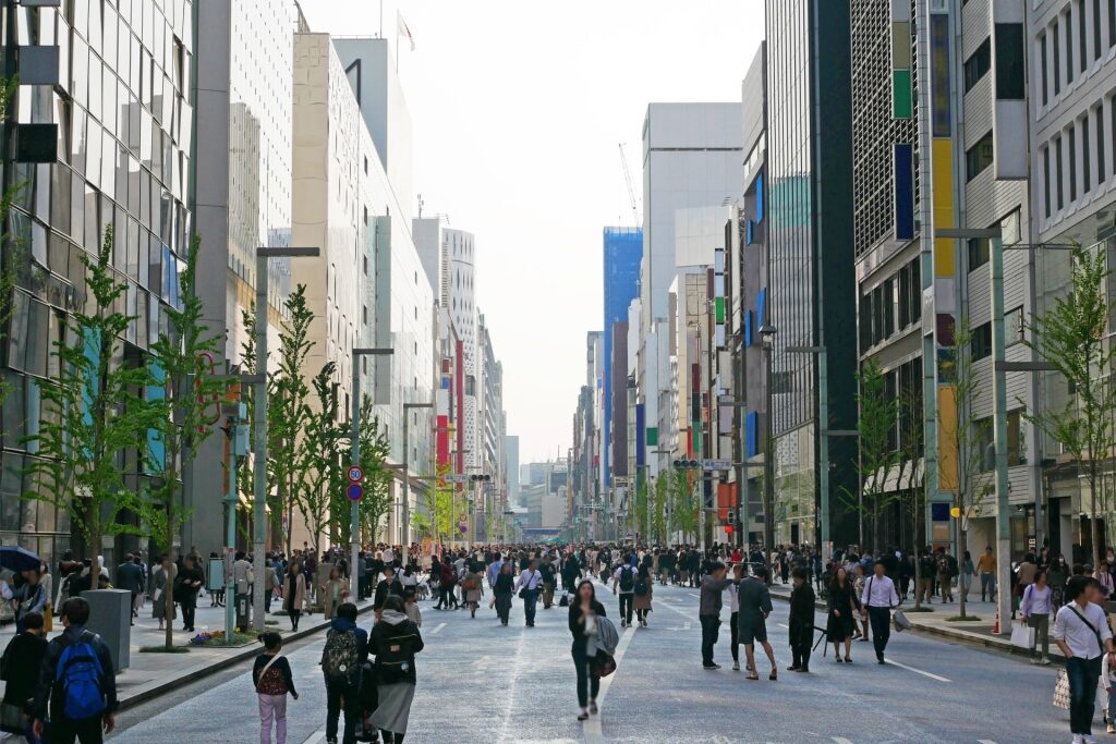 Ginza Tokyo street lined with luxury shops and modern buildings