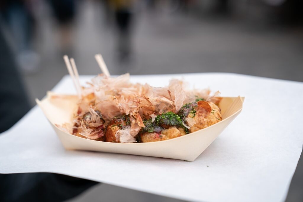 Traditional Osaka takoyaki topped with bonito flakes and sauce