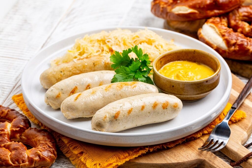 Traditional Bavarian Weisswurst with mustard and pretzel
