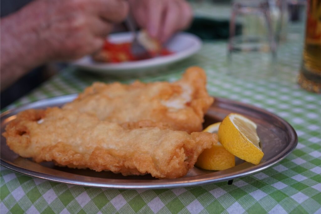 Golden fried Filetti di Baccalà served with lemon wedges