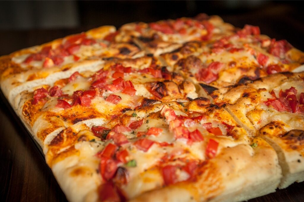 Rome street food pizza al taglio cut into rectangular slices