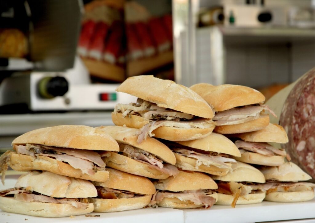 Freshly made porchetta sandwich displayed at a food stall