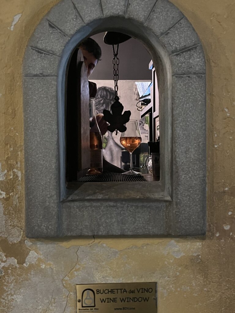 Babae, one of the many iconic wine windows in Florence Italy