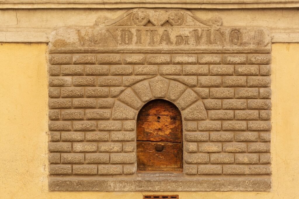 View of one of the many iconic wine windows in Florence Italy