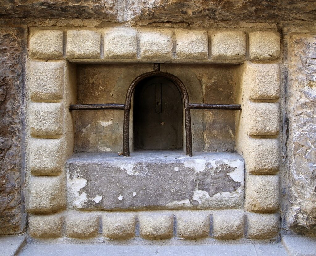 Historic Florentine wine window, or buchetta del vino, on a stone wall