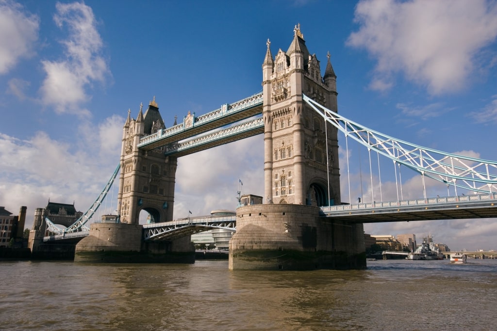The iconic London Tower Bridge spans the River Thames, showcasing historic Victorian architecture.