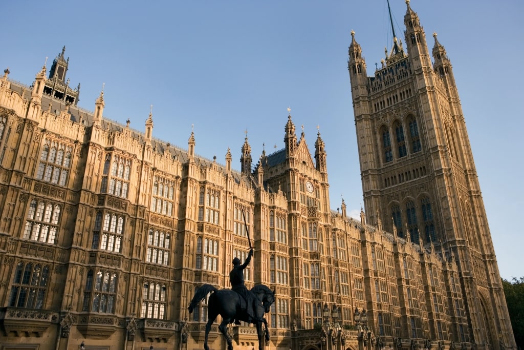 The Houses of Parliament in London, viewed from Parliament Square, showcasing the iconic Gothic architecture of the Palace of Westminster