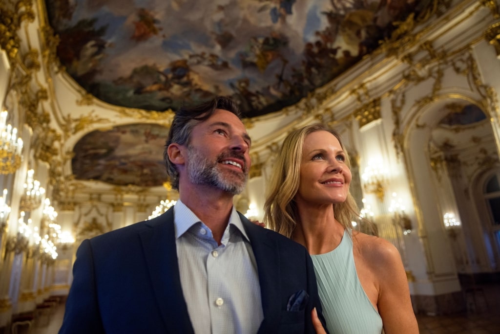 A couple standing inside the stunning Great Gallery of the historic Schloss Schönbrunn located in Vienna, Austria.