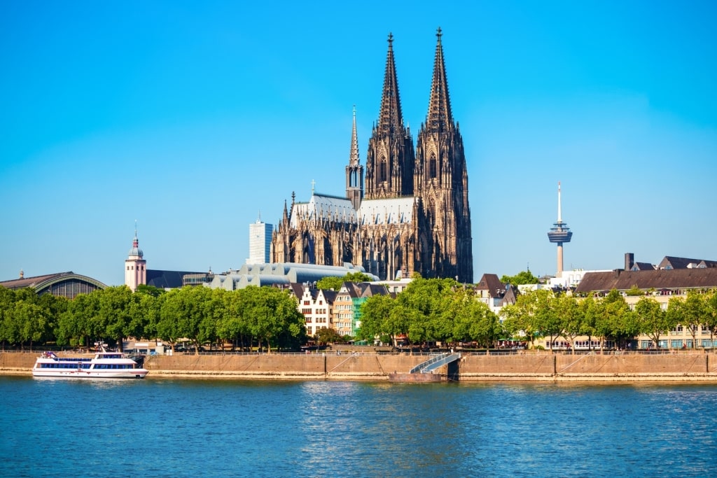 Cologne Cathedral and Hohenzollern Bridge across the Rhine River in Cologne, Germany