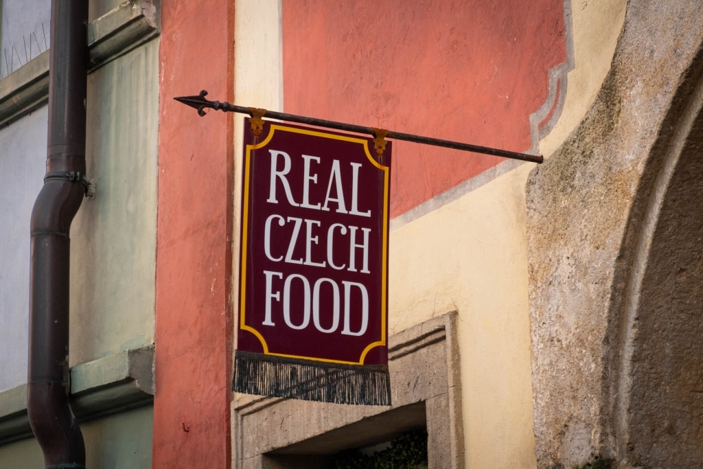 A distinctive Czech food storefront sign highlights traditional restaurant exterior architectural elements. 