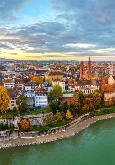 Basel, Switzerland on the Rhine River at dusk in autumn