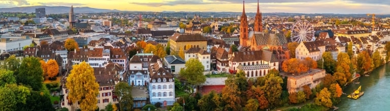 Basel, Switzerland on the Rhine River at dusk in autumn