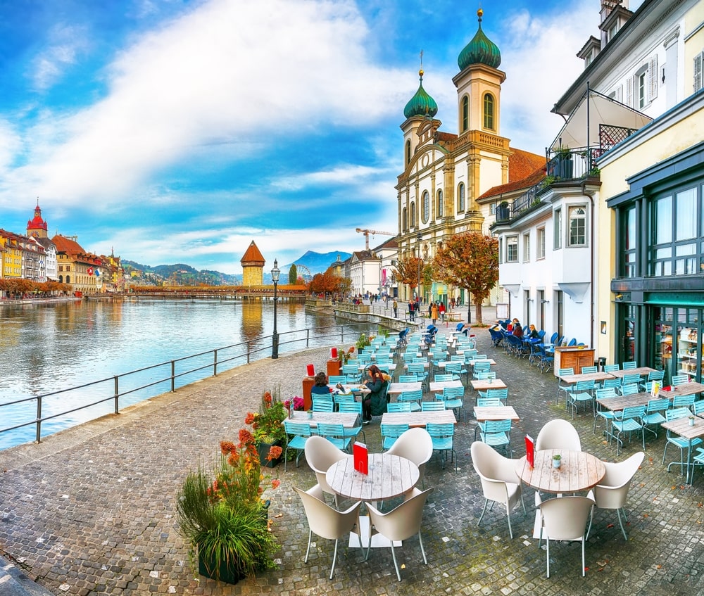 Stunning historic city center of Lucerne situated along the River Reuss, featuring the Chapel Bridge and the Jesuitenkirche Church.