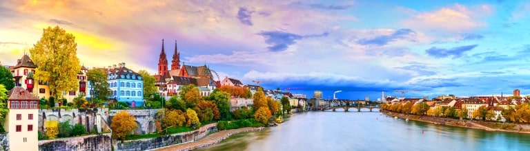 Basel, Switzerland on the Rhine River at dusk in autumn.