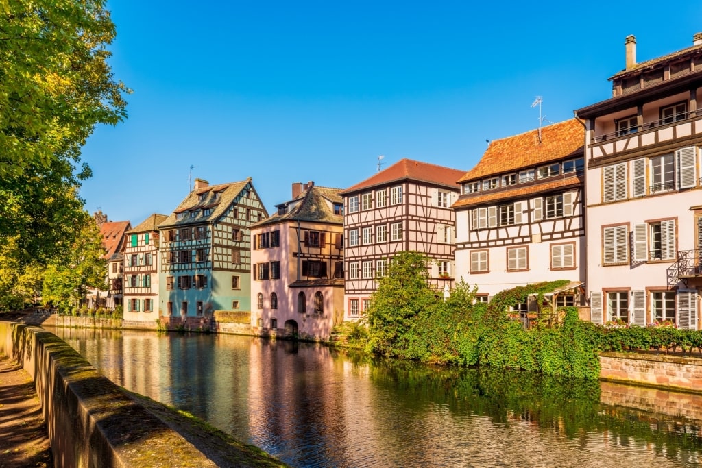 Historic downtown Strasbourg half-timbered architecture and vibrant riverside floral balconies celebrating Celebrity cruise love.