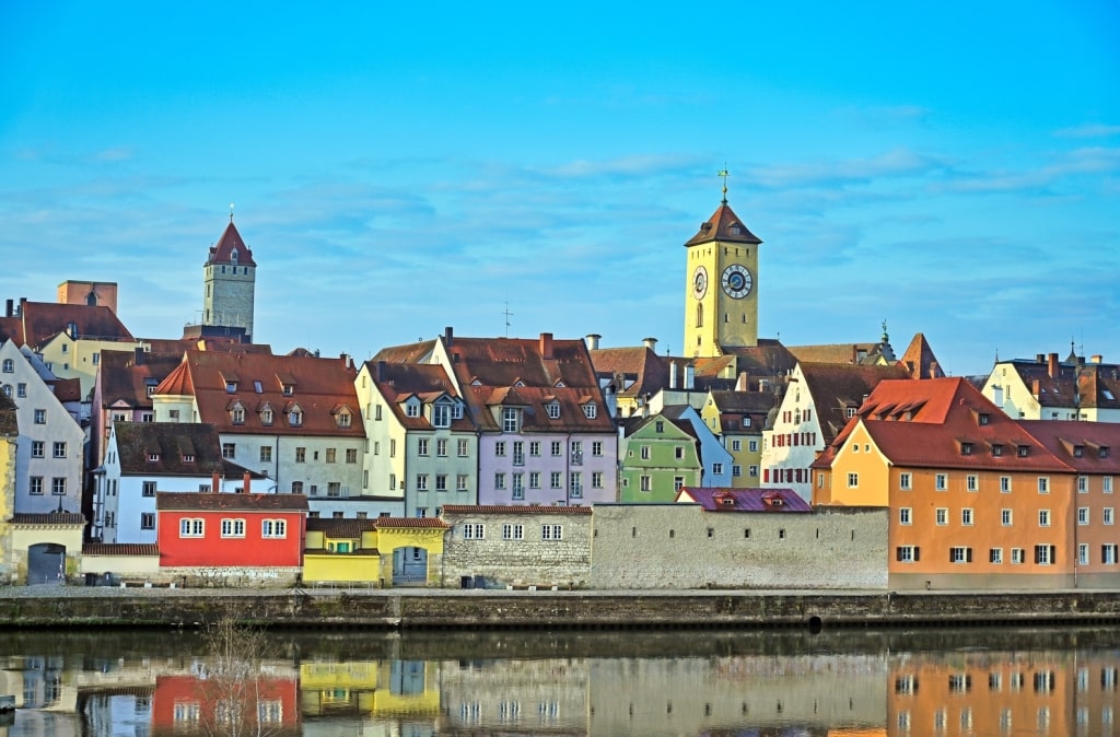 Colorful well-preserved medieval Bavarian architecture gracing the reflective Danube riverfront.