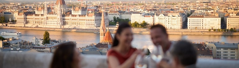 Diners enjoy a rooftop view of the majestic Hungarian Parliament Building across the river.