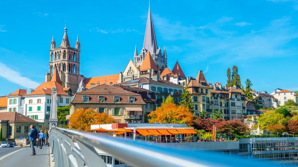 Lausanne Cathedral towers above the historic old town, framed by colorful autumn trees