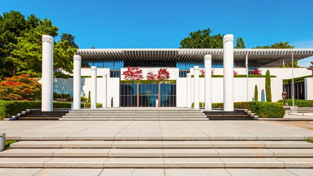 Tall white pillars and grand stone steps lead to the Olympic Museum entrance