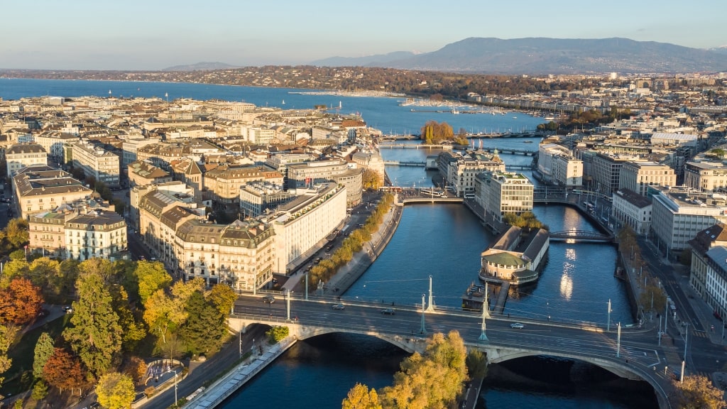 An aerial view of the Rhone River flowing through Geneva into Lake Geneva.