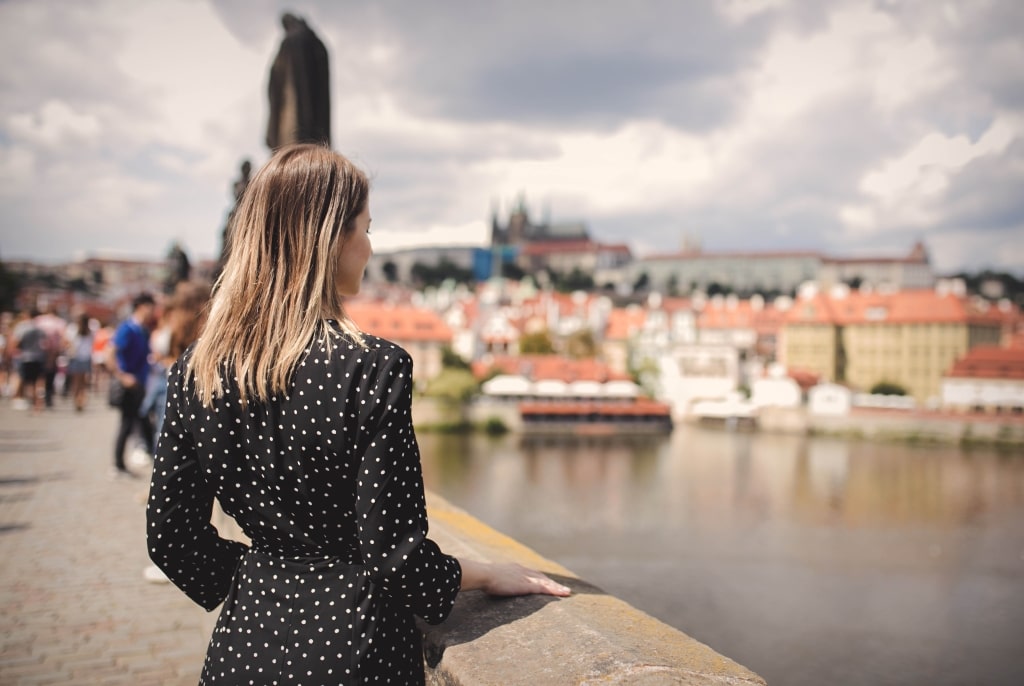 Woman on Charles bridge in Prague, Czech Republic.