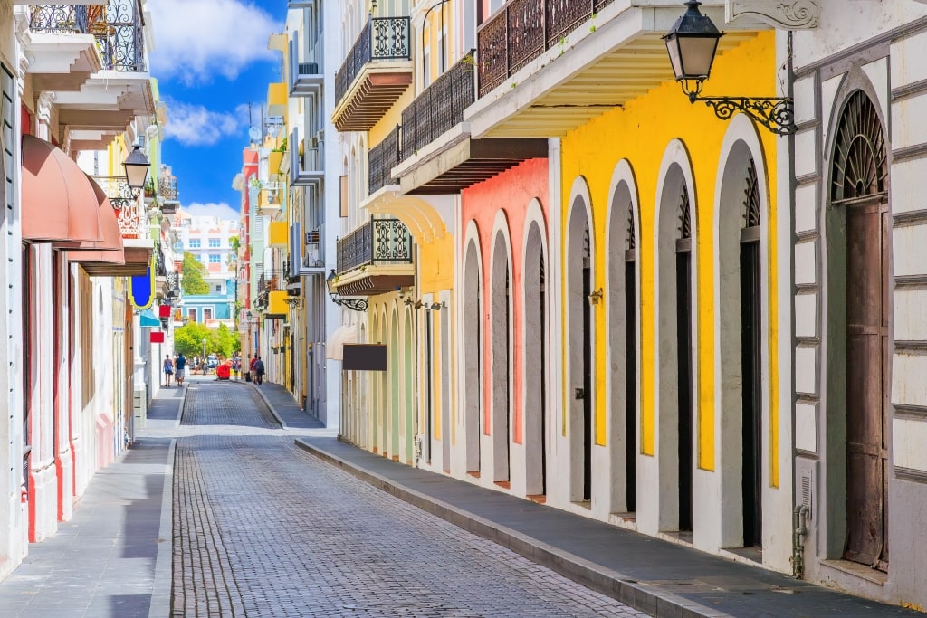 Old San Juan cobblestone streets highlight brightly colored colonial buildings flanking narrow historic pathways.