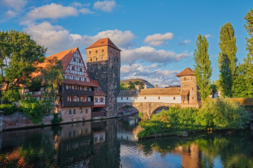 A scenic view of the historic Henkersteg bridge and traditional old town architecture at sunset in Nuremberg, Bavaria, Germany