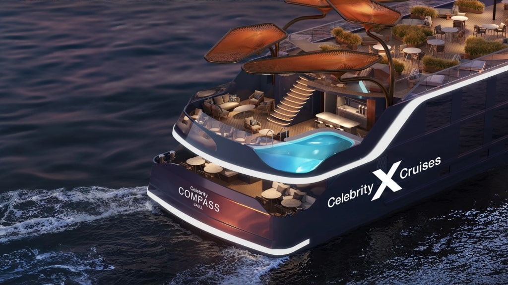 An aerial view of the illuminated aft pool deck on Celebrity Compass.