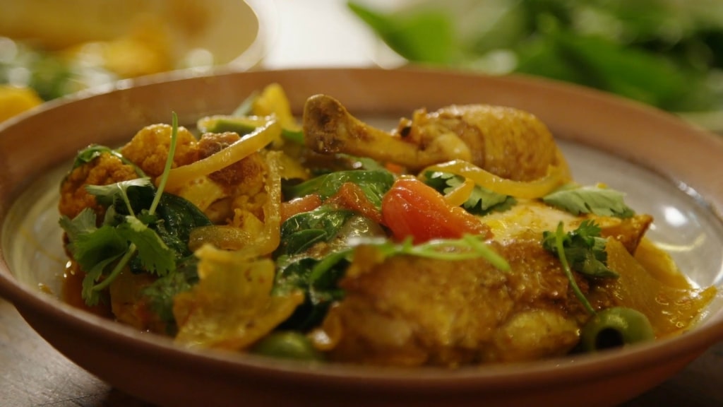 A traditional Moroccan chicken tagine served with tender vegetables and fresh herbs.