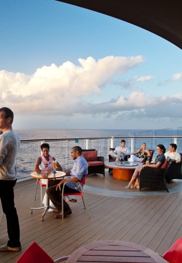 Group of people enjoying cocktails at the Sunset Bar onboard Celebrity Solstice SL, drinks, lifestyle imagery