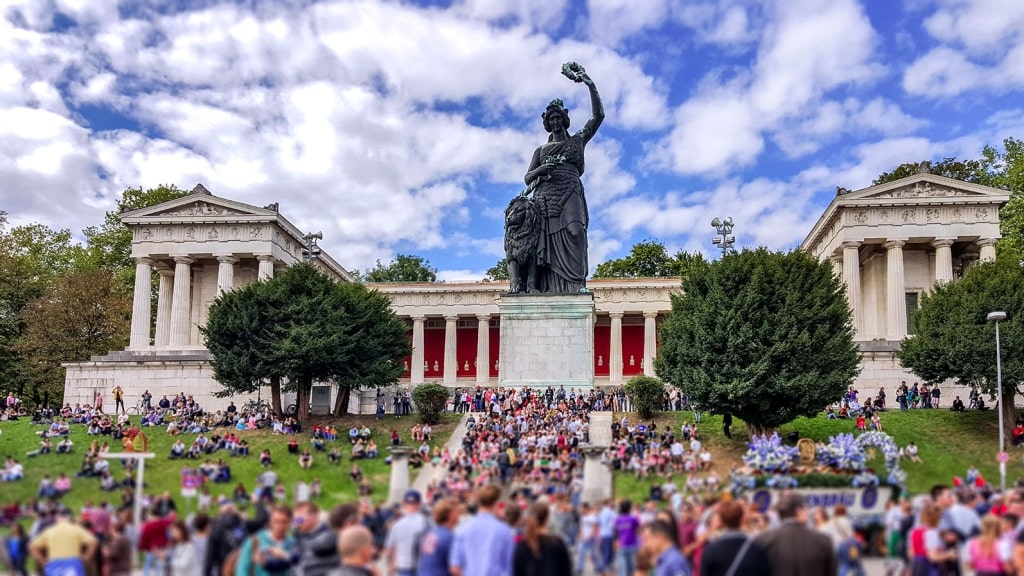 Crowds gather around the iconic Bavaria statue during Munich's Oktoberfest celebration.