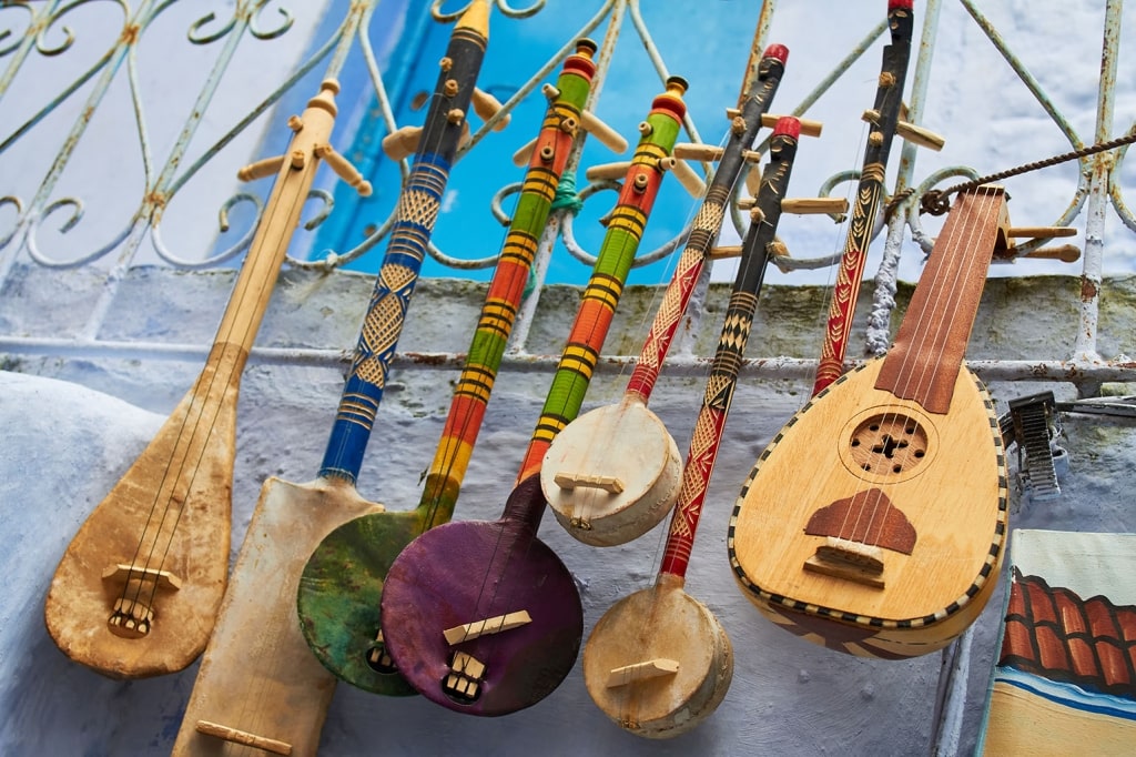 A collection of vibrant, hand-crafted Moroccan lutes and traditional stringed instruments.