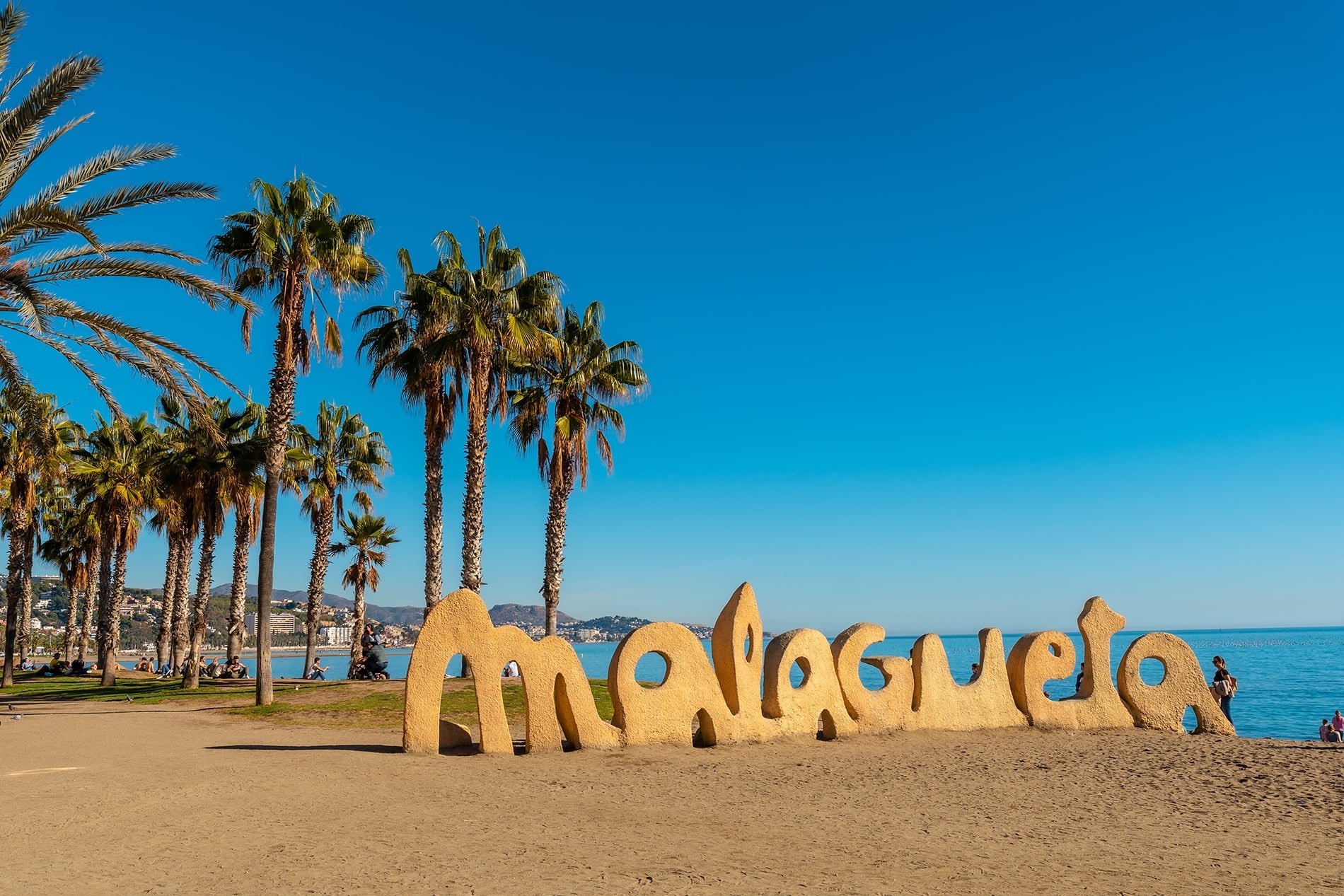 Malagueta beach and its palm trees in the city of Malaga, Andalusia, Spain.