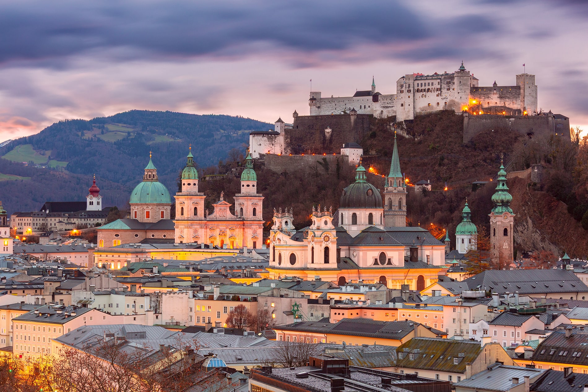 Sunset view of Salzburg, Austria, featuring Salzburg Cathedral and Hohensalzburg Fortress