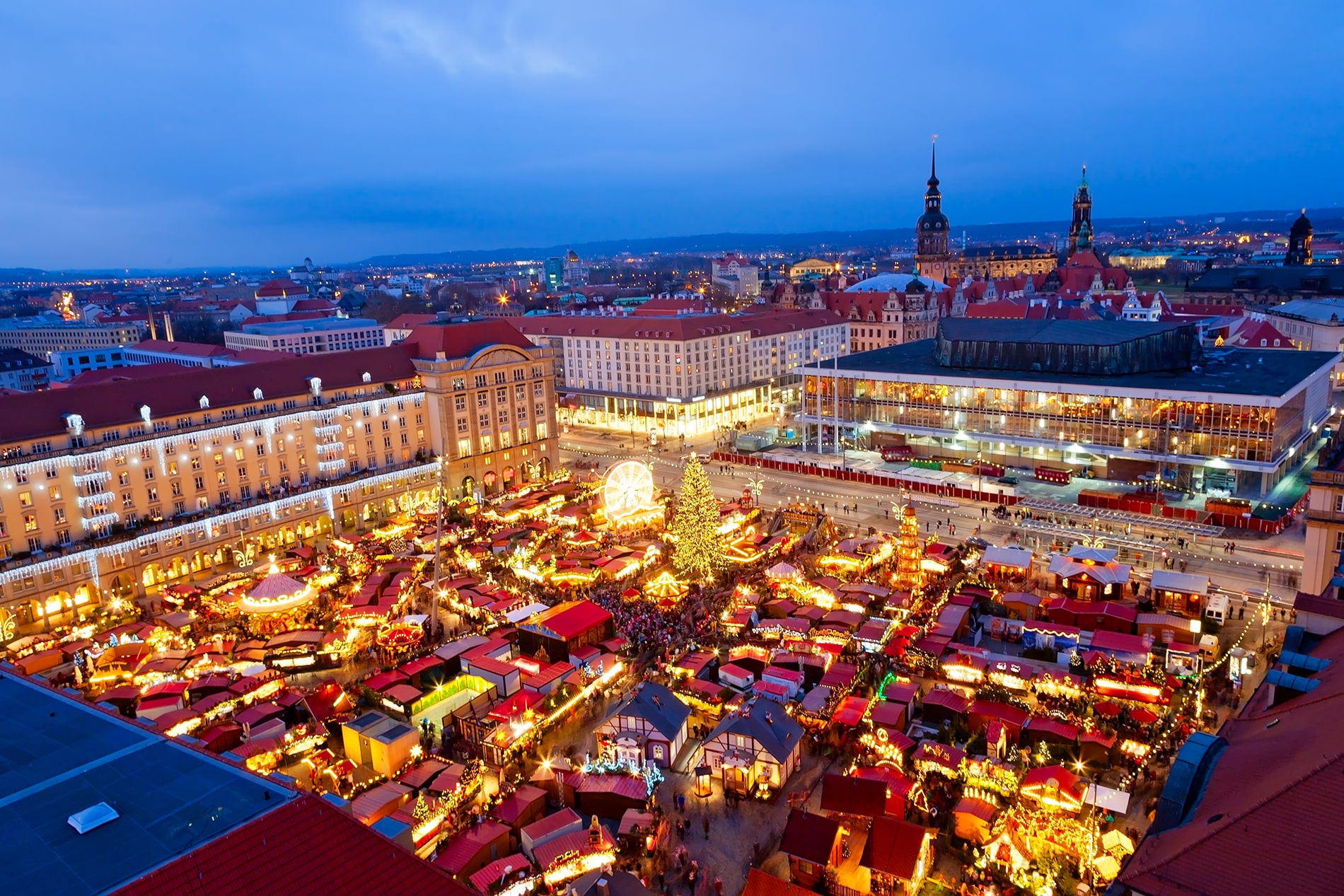 Under the cloak of twilight, the Striezelmarkt Christmas market in Dresden’s Altmarkt square radiates a magical glow as seen from above.