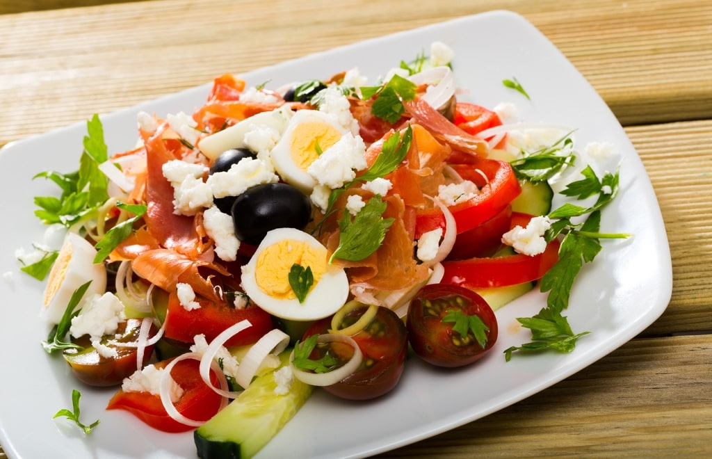 Shopska salad, traditional Bulgarian salad prepared from tomatoes, cucumbers, pepper and cheese.